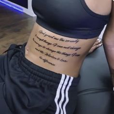 a woman with a tattoo on her stomach