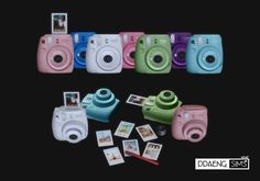 several polaroid cameras sitting next to each other on top of a black table with pictures