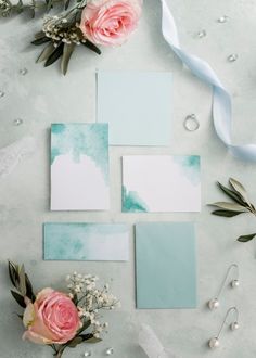 some flowers and cards on a table with pearls, ribbons and beads around them for an artistic look