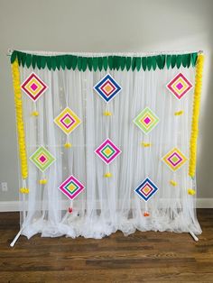 the curtain is decorated with colorful beads and tassels on it's sides