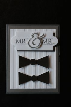 a wedding card with two black bow ties