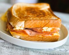 a toasted sandwich with ham and cheese on a plate