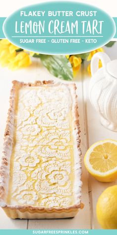 a lemon cream tart on a cutting board next to sliced lemons and flowers