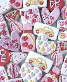 many decorated cookies are arranged in the shape of hearts and other things to be eaten