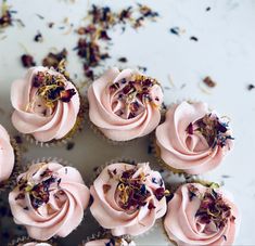 cupcakes with pink frosting and dried flowers on top