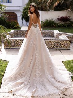 a woman in a wedding dress standing outside