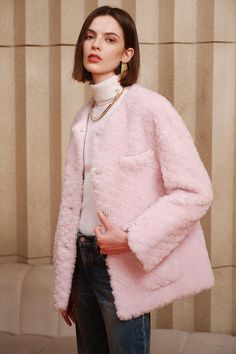 Crafted from premium wool sourced from large-grained sheep, this garment boasts a soft and voluminous texture that's visually captivating and layered, exuding a lavish demeanor that envelops you in warmth and comfort. This fur coat triumphs in winter styling, with its soft pink hue imparting a touch of informality that's both luxurious and youth-enhancing. Lustrous pearls add a high-end allure, while the pockets are adorned with intricate embellishments, elevating the detailing. The addition of Luxury Fluffy Outerwear For Fall, Luxury Fluffy Long Sleeve Outerwear, Luxury Long Sleeve Fluffy Outerwear, Elegant Fluffy Winter Outerwear, Luxury Wool Fur Coat For Winter, Luxury Long Sleeve Sweater Coat For Winter, Luxury Fluffy Fur Coat For Fall, Luxury Fluffy Winter Fur Coat, Luxury Fluffy Fur Coat For Winter