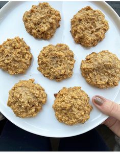 a white plate topped with cookies and oatmeal on top of a table