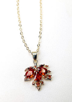 Celebrate the beauty of fall with this stunning gold-plated maple leaf pedant. Featuring red zirconia stones, it's the perfect accessory to complement your autumnal wardrobe. 

#mapleleafpedant #fallfashion #goldplated #zirconia #autumnal Red Maple Leaf, Red Maple, Leaf Pendant, Women Accessories Jewelry, Kuwait, Leaf Design, Maple Leaf