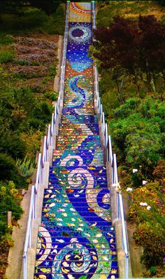 the stairs are painted with blue and green designs