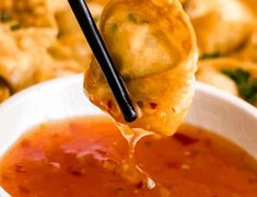 a spoon full of soup being lifted from a bowl