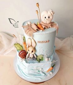 there is a cake that has two stuffed animals on it and carrots in the middle