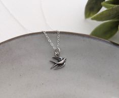 This dainty bird charm measures approximately 14mm (around 1/2"). Necklace card reads "with brave wings she flies". All components of this necklace are made of solid .925 sterling silver. Can be sent directly to gift recipient. Shipping address can be updated at checkout. Will arrive in a gift box ready to make the perfect gift. Tiny Silver Charm Necklaces As Gift For Her, Tiny Sterling Silver Charm Necklace For Her, Tiny Silver Charm Necklace As Gift For Her, Adjustable Delicate Sterling Silver Charm Necklace, Sterling Silver Tiny Necklace Gift For Her, Tiny Silver Necklace For Her, Silver Tiny Necklace For Her, With Brave Wings She Flies, Silver Bird Necklace