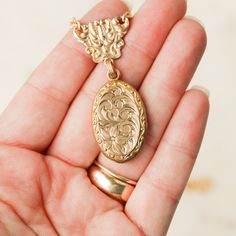 This one-of-a-kind necklace is composed of: Victorian gold filled locket and watch fob connecting link from the late 1800s. The locket features hand engraved scrollwork and floral details. This gold filled necklace measures a standard 18” on a modern 14k gold filled chain. The locket measures 1.25" in length and drops 2" from the chain. Antique Gold Pendant Jewelry For Keepsake, Antique Gold Keepsake Pendant Jewelry, Victorian Yellow Gold Pendant Locket Necklace, Brass Locket Necklace For Keepsake, Bronze Oval Pendant Jewelry With Antique Finish, Heirloom Antique Gold Pendant Necklace, Bronze Oval Pendant With Antique Finish, Bronze Antique Finish Oval Pendant Jewelry, Engraved Medallion Necklace For Formal Occasions