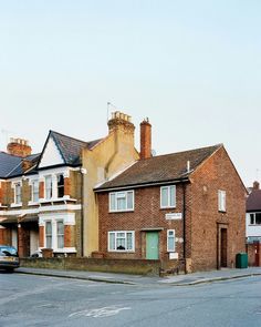 an empty street in front of some brick houses