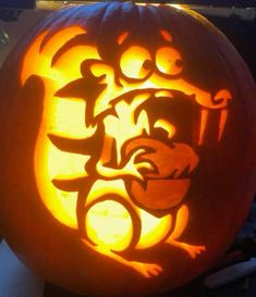 a carved pumpkin with an image of a cat on it's face in the center