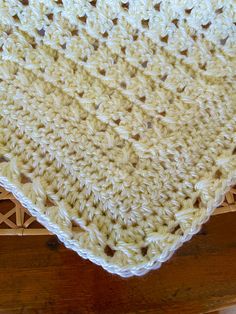 a crocheted dishcloth sitting on top of a wooden table