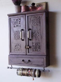 an old wooden cabinet is hanging on the wall