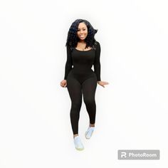 a woman in a black bodysuit is standing on one leg and smiling at the camera