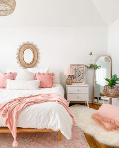 a bedroom with white walls and pink accents