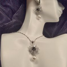 Beautiful Black And Clear Cz Pierced Earrings, With Faux Pearl Drop, 17" Necklace With 2" Extender, Black And Clear Czs With Faux Pearl Drop, And Size 7 Black And Clear Cz Ring. All Flowers Are 3/4" Across, Earrings Have 2" Overall Length And Necklace Has 1 3/4" Length From Chain. I Even Included A Picture Of This Nana's Wrinkly Old Hand With The Ring On So You Can Estimate How Much Better It Will Look On You! Seriously This Looks Very Expensive, Ring Is Marked '925'. Silver Flower Shape Jewelry For Evening, Silver Flower Shaped Jewelry For Evening, Elegant Black Crystal Jewelry, Silver Flower Shaped Jewelry Sets For Formal Occasions, Formal Silver Jewelry Sets With Flower Shape, Elegant Crystal Jewelry With Black Diamonds, Silver Flower Shape Jewelry Sets For Formal Occasions, Elegant Black Jewelry Sets With Matching Earrings, Black Cubic Zirconia Jewelry With Sparkling Stones