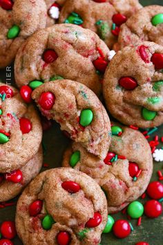 chocolate chip cookies with candy and sprinkles on a green plate, ready to be eaten