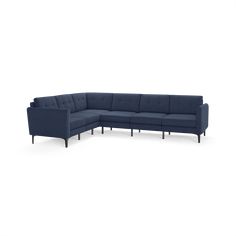 a blue sectional couch sitting on top of a white floor