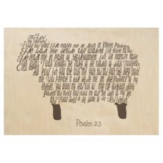 a wooden plaque with an image of a sheep in the center and words written on it