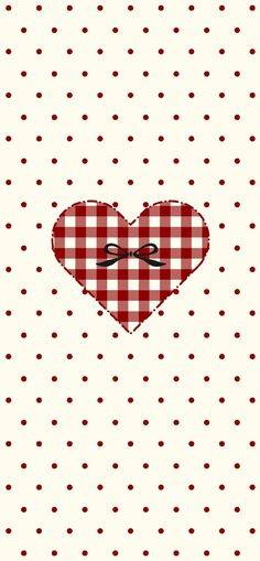 a red and white checkered table cloth with a heart shaped bow on the side