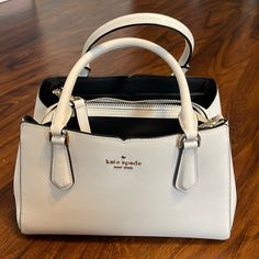 Kate Spade New York Tippy Small White Leather Triple Compartment Satchel. Removable Strap. Multiple Interior Zipper And Slip Pockets. Barely Used. Great Condition. No Damage. Smoke Free Environment. 7"H X 10.5"W X 4"D Handle Drop: 5" Drop Length: 22" Refined Grain Leather Unlined Metal Pinmount Logo Satchel With Zip Closure Interior Zip Pocket Interior Slide Pockets Dust Bag Not Included Imported Kate Spade Double Handle Satchel With Removable Pouch, Kate Spade White Top Handle Satchel, White Kate Spade Bag With Zipper Closure, Classic Kate Spade Bags With Silver-tone Hardware, Kate Spade Crossbody Shoulder Bag With Silver-tone Hardware, Kate Spade Bag, Kate Spade New York, White Leather, Zip Pockets