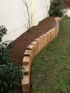 a garden bed made out of wood and mulch