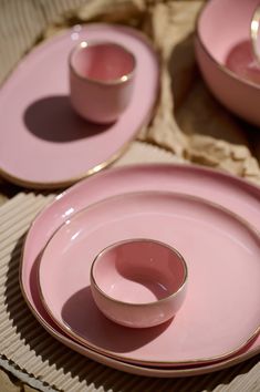 pink dishes with gold rims and matching saucers