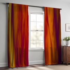 an orange and red curtain hanging in front of a window