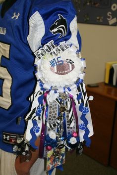 a person wearing a football jersey holding a trophy