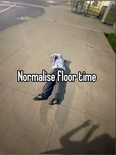 a man laying on the ground with his head down and text reading normalise floor time