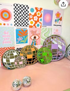 there are some balls on the table with different colors and designs around them, as well as pictures