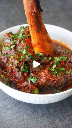 a close up of a bowl of food with meat