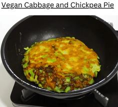 an omelet is being cooked in a frying pan on the stove top