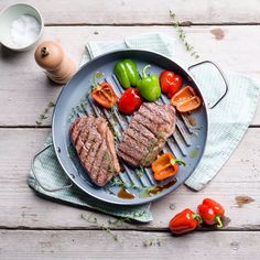 steak with tomatoes and peppers on a plate