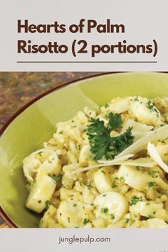 a green bowl filled with pasta and garnished with parsley