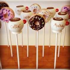 there are many donuts on the stick with chocolate frosting and sprinkles