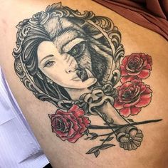 a woman's stomach with roses and an image of a wolf in the frame