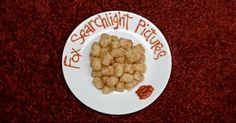 a white plate topped with food on top of a red carpeted floor next to a sign