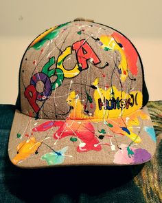 a hat with graffiti on it sitting on top of a couch