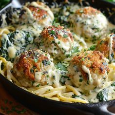 a skillet filled with pasta and meatballs