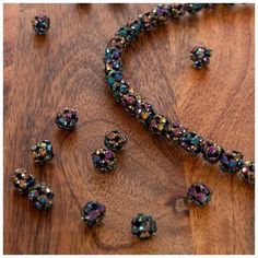 a necklace and earring set on a wooden surface