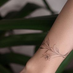 a woman's arm with a flower tattoo on the left side of her body