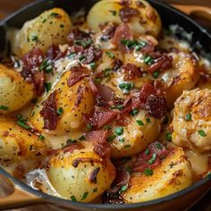 a skillet filled with potatoes covered in bacon