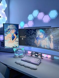 two computer monitors sitting next to each other on top of a white desk in front of blue and purple hexagonal lights