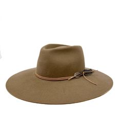 Remaining true to our classic shapes but with a twist! The montana fedora is made from a lite stockman felt and has a slightly rounder crown and has a stiff and sturdy feel . Trimmed with deer skin leather and feather, she will be your new fall fave! Add "custom embroidery" to make it more personal. Made in the U.S.A small 21-22 inches medium 22-23 inches large 23-24 inches Rodeo Fedora Felt Hat With Feather Trim, Bohemian Fedora Felt Hat With Feather Trim, Curved Brim Fedora For Ranch, One Size, Adjustable Wide-brim Fedora With Feather Trim, Western-style Brimmed Fur Felt Fedora, Fall Faves, Felt Fedora, Deer Skin, Custom Embroidery